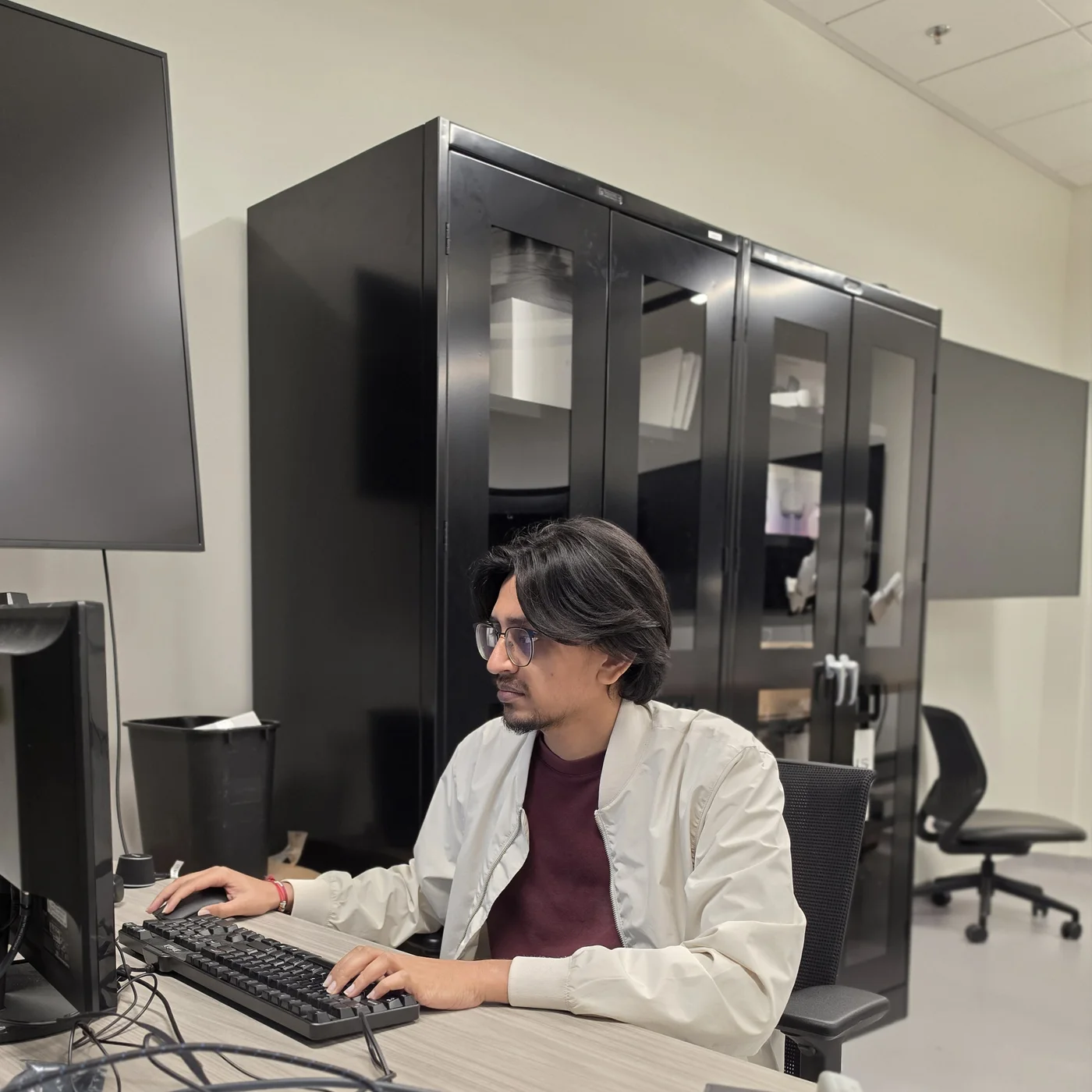 Dhruv Patel working at a workstation in the SJSU Robotics and Digital Twin Lab